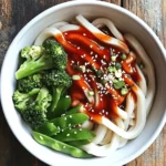 Udon noodles, a beloved staple in Asian cuisine, have captured the hearts (and stomachs) of food enthusiasts around the world. Known for their thick, chewy texture and versatility, these Japanese noodles serve as the perfect canvas for a multitude of flavors, making them a popular choice in both home-cooked meals and gourmet dining. Among the many delicious ways to prepare udon, one standout dish is Quick and Zesty Chili Oil Udon Noodles.